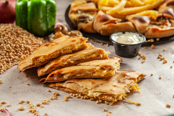 Whole wheat stuffed naan with barley and ingredients in the background.