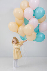 Blonde girl with balloons in the interior