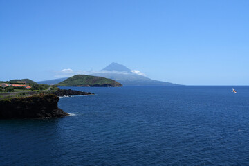 Fototapeta premium Der Vulkan Pico von der Nachbarinsel Faial aus über das Meer gesehen