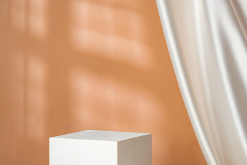 Minimalist decor featuring a white cylinder and draped fabric in a warm-toned interior with soft...