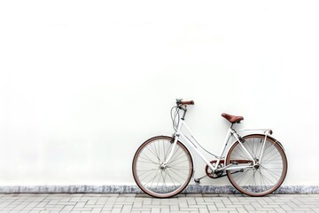 Fototapeta premium A minimalist white bicycle parked against a plain wall, showcasing simplicity and elegance in urban transportation.
