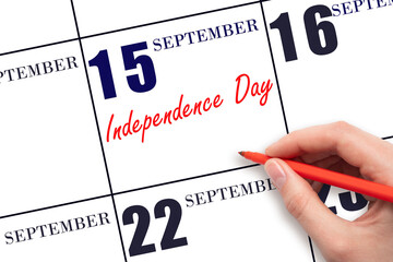September 15. Hand writing text Independence Day on calendar date. Save the date.