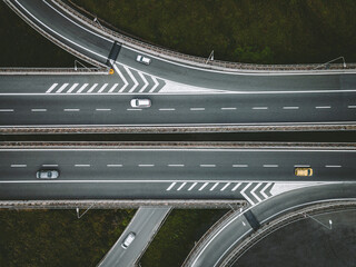 Aerial drone view of highway road intersection with cars in Italy