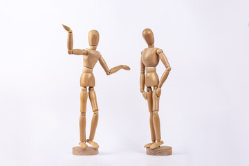 Wooden figures representing an arguing couple, isolated on white background. Copy space. Concept of couple, argument and conflict