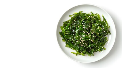 Fototapeta premium Fresh seaweed salad with sesame seeds on white plate