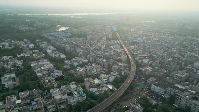 noida city and drone moving closer to metro train bird eye view in noida delhi in india