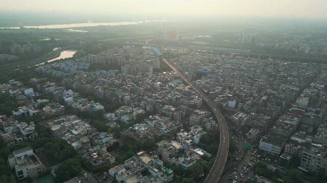 noida city and drone moving closer to metro train bird eye view noida in delhi in india