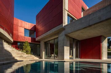 Red concrete renaissance house with curved lines.