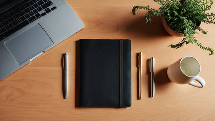 A flat lay of office essentials including a laptop, notebook, pen, coffee mug, and a plant, neatly arranged on a wooden desk for a productive workspace vibe