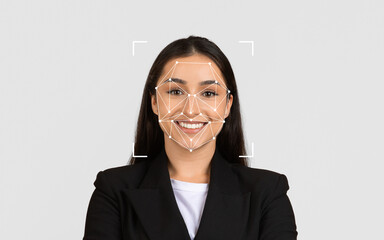 A woman smiles confidently while a facial recognition grid overlays her face in a neutral...