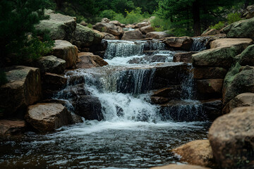 Fototapeta premium Cascading Waterfall in a Rocky Creek