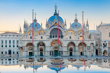 Sunrise in San Marco square with Campanile and San Marco's Basilica. The main square of the old town. Venice, Veneto Italy. Reflection on the flooded square.