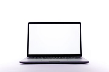 A laptop computer sits on a white table