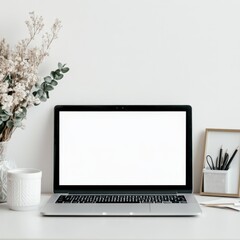 Laptop with blank display, potted plant on white table.