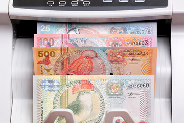 Surinamese dollar in the counting machine