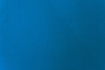 Light navy blue color paint on cement wall texture as background.