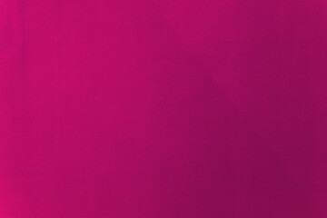 Pink or dark pink mixed with purple color paint on cement wall texture as background.