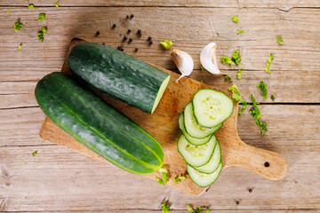 Top view of fresh cucumber slices on wooden board &ndash; healthy and nutritious option