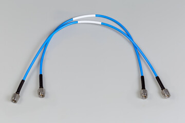 Two high-frequency cable adapters with silvery coaxial threaded connectors