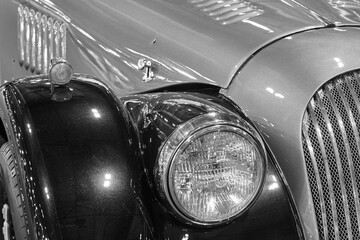 Classic car front part detail in black and white. Horizontal