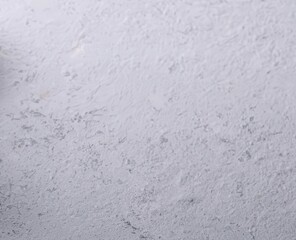 Obraz premium A textured white surface with subtle variations, ideal for background use in design projects, photography, and creative works. Isolate on clean background
