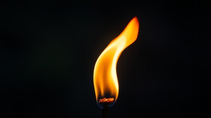 A single matchstick burns brightly against a black background.