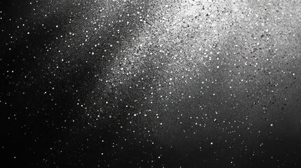 A mesmerizing display of white glitter particles scattered against a black background, creating a magical, starry effect.