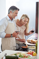 Married people, together and wine with cooking, love or laugh for food by helping in kitchen. Mature man, happy woman and affection with bonding, healthy meal or nutrition in preparing dinner at home
