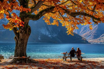 A couple enjoys a peaceful moment by the lake under a tree with vibrant autumn foliage. AI.