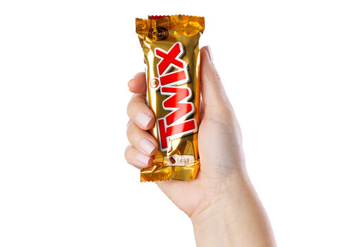 Woman hand holding Twix chocolate bar