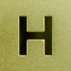 Letter H on a golden grained shiny metal surface. English alphabet.