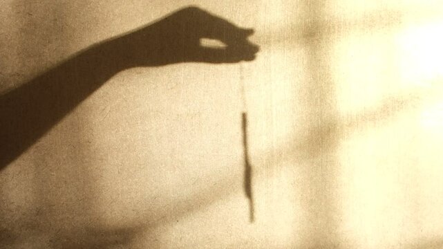 Blurred shadow of child hands on wall. Child playing with Christmas decorations, Christmas tree and deer toys. Playing with light and shadow. Atmospheric mood. Waiting holidays