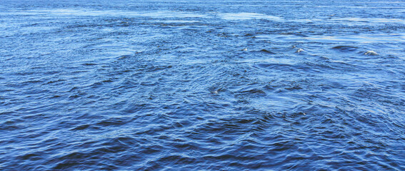 The texture of ripples on the water. Natural background.