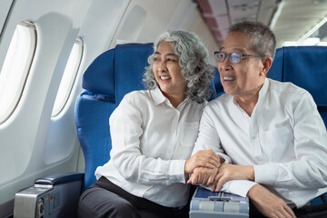 Mature couple sitting a private jet and headed on a trip.