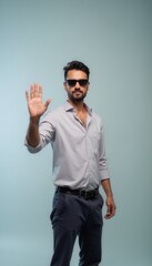 Fototapeta premium Casual Man Wearing Sunglasses and Shirt with Hand Raised Gesture