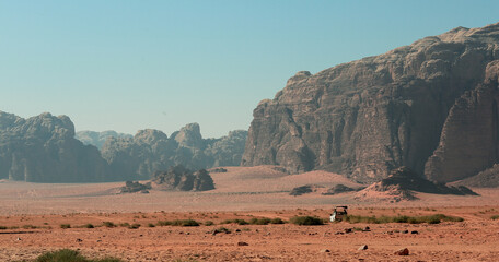 Exploring the vast beauty of Wadi Rum Desert in Jordan with towering sandstone formations under a clear blue sky