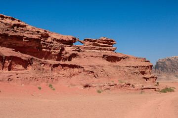 Fototapeta premium Exploring the stunning rock formations of Wadi Rum Desert in Jordan under a clear blue sky