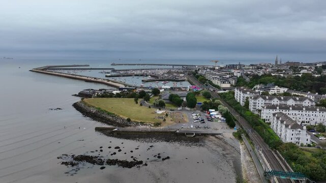 D&uacute;n Laoghaire Harbour, Dublin, Ireland, September 2024. Drone pushes east from Salthill and Monkstown Dart Station passing the West Pier following the coast towards the old Coal Harbour and Marina.