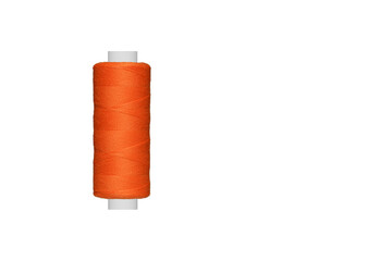 orange spool of sewing thread isolated on white background close up