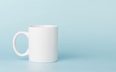 white cup for tea or coffee on a blue background