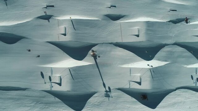 Aerial drone view of Madonna di Campiglio and ursus snowpark in Val Rendena dolomites trentino Italy. Snowboarder skier jumps on kicker in snowpark.