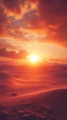 Fototapeta premium A breathtaking sunset over a vast landscape, with vibrant orange and red hues illuminating the sky and reflecting off rolling sand dunes