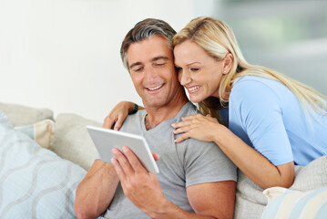 Lounge, home and couple with tablet, watch and browsing of movie, showing and subscription for entertainment. House, relax and woman with man, streaming and happy in living room, scroll and bonding