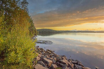 Tranquil lakeside scene at sunset