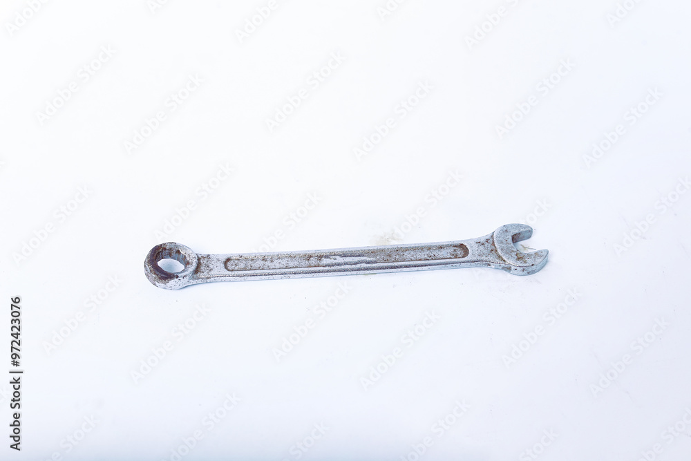 Wall mural old wrench isolated on a vertical white background. one hand tool top view in the center, no people.