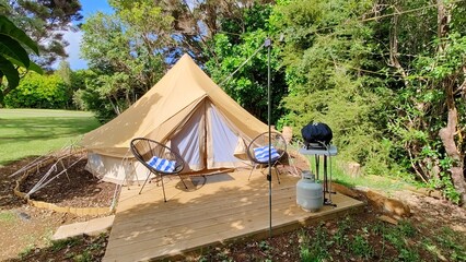 Cozy lit and decorated tipi tents at a glamping campground