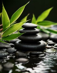 Stacked black spa stones with bamboo leaves surrounded by water, creating a serene and calming zen-like atmosphere for relaxation.