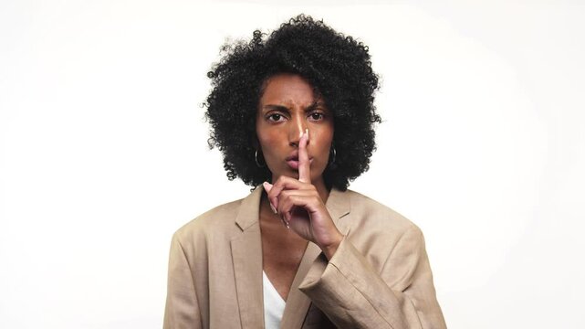 Businesswoman Gesturing Shh Be Quiet Please on White Background