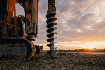 Building activity on construction site. Close-up view of heavy drilling machine..
