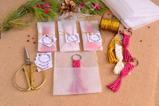 Christmas gifts making key chain macrame handmade presents wrapping process, paper ribbon scissors, pine tree background, new year party presentscrafting, winter wedding guests favors souvenirs ideas